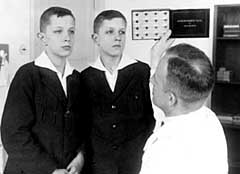 American eugenicist Dr. Otmar Freiherr von Verschuer examines twins. His assistant, Josef Mengele, would continue these experiments at Auschwitz.