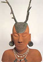 A reproduction of 'Hopewell Man', adorned with a native-copper headpiece, earspools, and three strands of freshwater pearls embellished with copper and silver pendants.